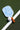 Pickleball paddle with blue pattern on a green court