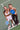 Two women on a tennis court holding pickleball paddles with 'Pulse Pickle' branding.
