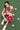 Woman_holding_a_red_pickleball_paddle_on_a_green_court_with_pickleballs_around_her. - Pulse Pickleball