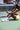 Woman_sitting_on_a_pickleball_court_holding_a_pulse_pickleball_paddle_and_ball - Pulse Pickleball