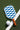 Checkered_paddle_with_brown_handle_and_white_ball_on_green_surface - Pulse Pickleball