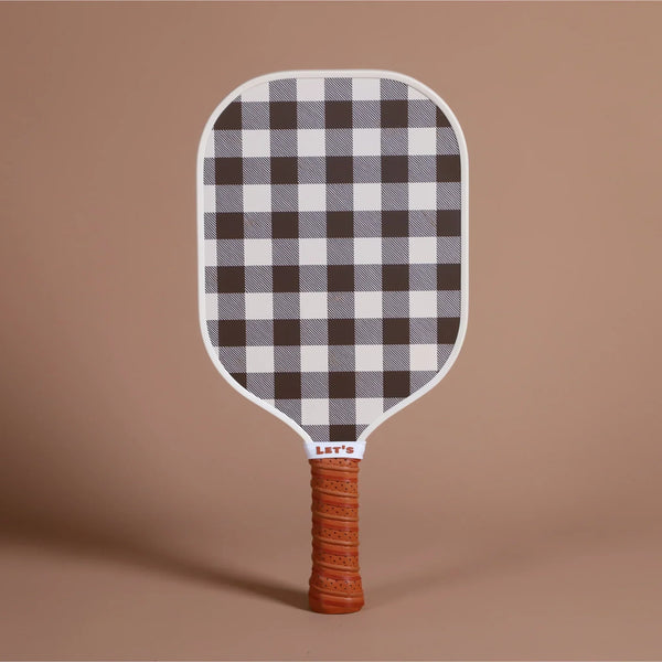 Fibreglass pickleball paddle with black and white checkered face and textured orange handle