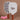 Two_pickleball_paddles_with_Pulse_branding_and_checkered_pattern_accompanied_by_pink_pickleballs_on_a_brown_background. - Pulse Pickleball