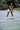 Woman playing pickleball on an outdoor court